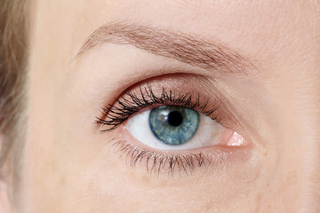 Fototapeta na wymiar Macro shot of blue woman's eye after lasic surgery