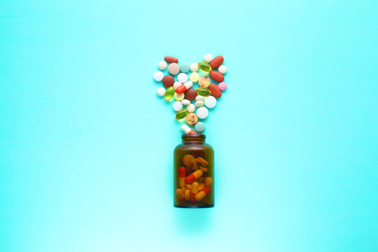 Medical pills and a bottle lie on the table. Medical concept