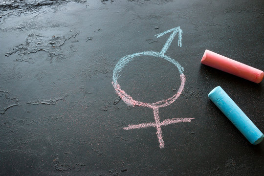 Colorful crayons and a symbol of a transgender