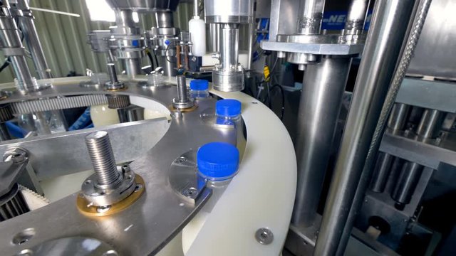 A working automatic milk bottle capper. 