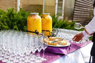 Bank of lemonade with citrus fruits on a buffet table