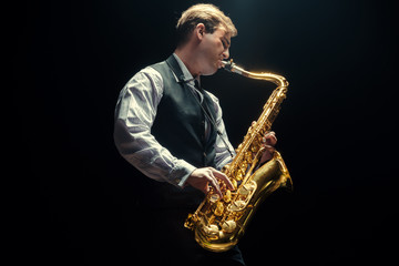Fototapeta na wymiar Young man playing the Saxophone