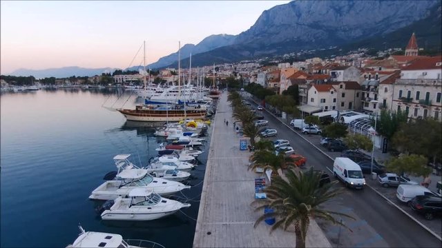 Aerial view on Makarska and marina at sunrise with Biokovo mountain in background. Makarska Riviera, Croatia 