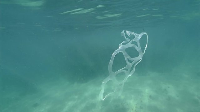 Plastic binding floats in ocean, close up