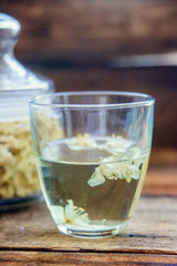 jasmine tea in a glass cup on the background of the old invoice board