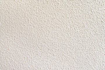 Texture of coarse rough light-colored concrete wall.
