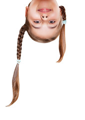 Funny girl with pigtails upside down . Insulated head closeup portrait on white background.