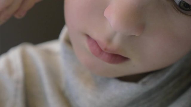 Extreme close-up shot of a boy sneezing