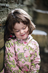 Young little girl portrait looking and smiling at the camera.