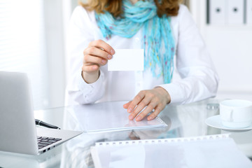 Obraz na płótnie Canvas Close-up of business woman giving a visit card