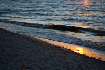Beautiful sunrise over the sea, orange red sun, purple blue and pink sky without clouds,  blue sea, sunny path, sand wave vacation