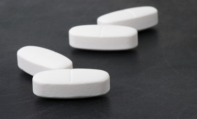 White pills on the black