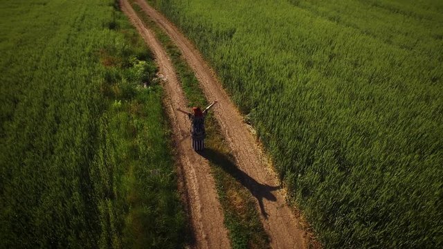 4K Aerial Point of View around Free Girl in Fields