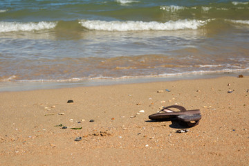 Sandals on the beach in Normandy