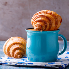 Croissant and Coffee with milk. Breakfast Fresh Baking.