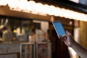 a man using smart phone in akihabara