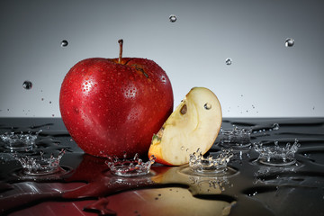 Apple with water drops on grey background