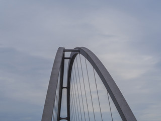 top of the steel suspension bridge arch with blue sky background