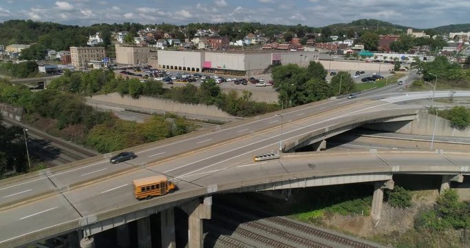 A daytime high angle aerial establishing shot of traffic on Route 51 in Rochester, Pennsylvania.  	