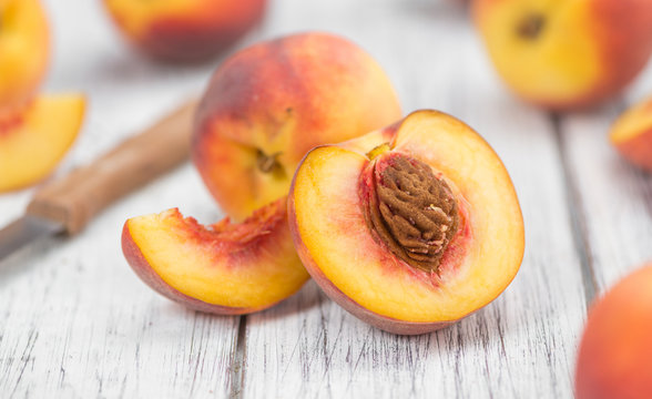Fresh Peaches on wooden background; selective focus