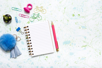 Pastel color flat lay with stationary accessories, notebook and pen for bloggers, students, office