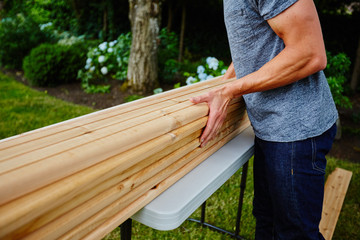 Man carrying wood to deck