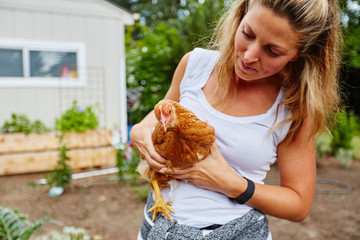 rural beautiful woman holding chicken