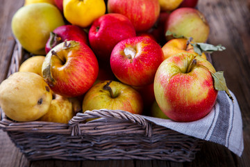 Fresh apples in a basket on an old wooden background.Food or Healthy diet concept.Super Food.Vegetarian.selective focus.Vintage style.