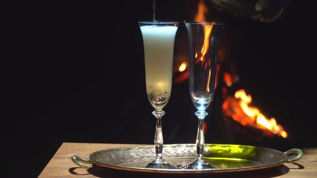 still life with champagne on the background of fire