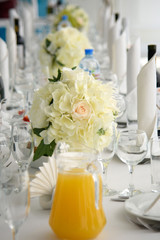 A Exquisite festive table with dishes for the customers. The restaurant business in the interior. A row of stand-up napkins.
