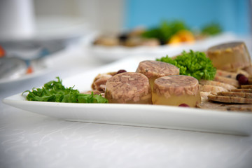 Exquisite festive table with dishes of meat jelly. The restaurant business in the interior. Delicious diner food.