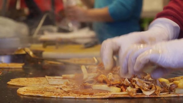 Adding Meat And Steaming Hot Sauce To Shawarmas - Close Up - Static