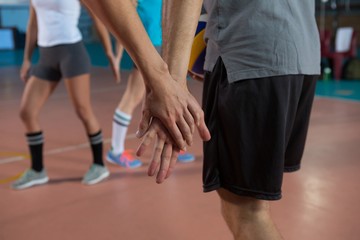 Cropped image of volleyball player holding hand with teammate