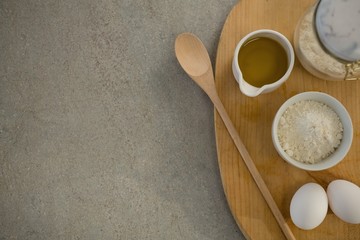 Obraz na płótnie Canvas Flour and oil with eggs on cutting board