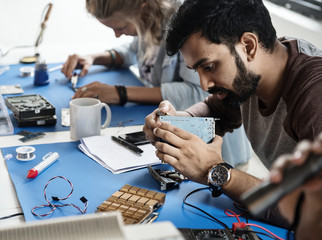 Technicians working on electronics parts