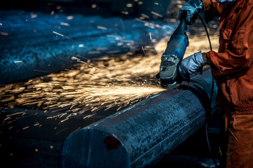 The workers in the steel mill are burnishing the steel