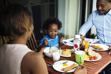 Black family having breakfast together