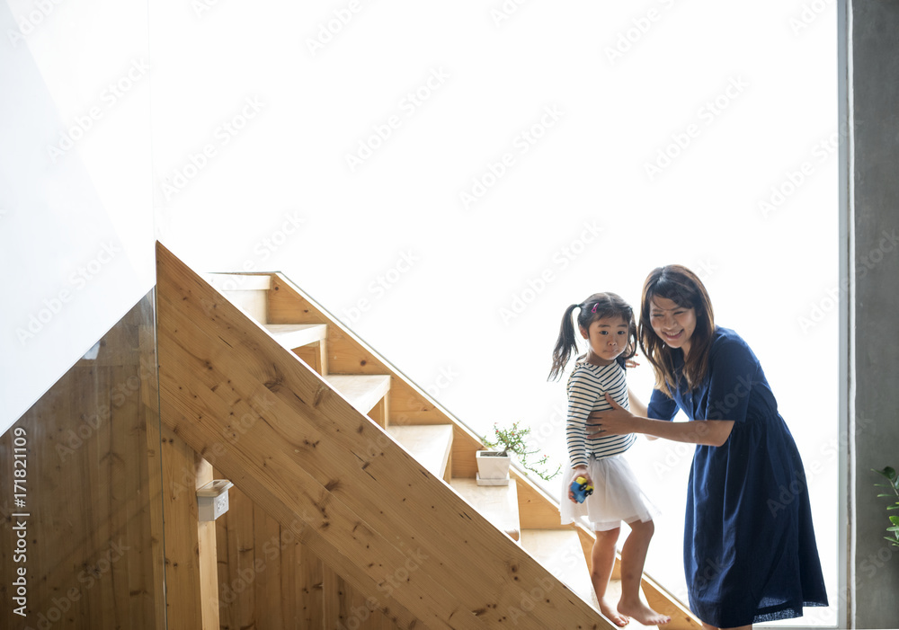 Wall mural Mother and daughter playing together