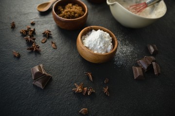 High angle view of flour with spice and chocolate bars