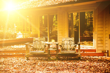 Outdoor wooden chairs at front yard at sunset
