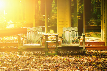 Outdoor wooden chairs at front yard at sunset. 