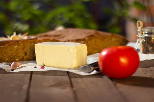 Feta cheese on a table with tomato, garlic, chilli pepper, pepper and crono diet bread