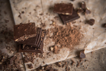 Dark chocolate stack with hazelnuts, selective focus