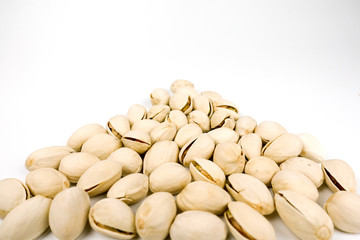 salted pistachio nuts on white background