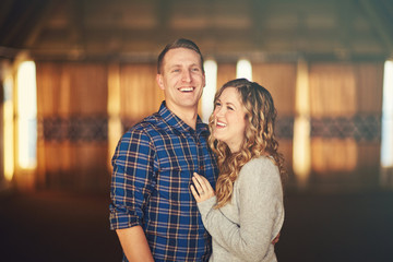 Fototapeta premium beautiful couple smiling and laughing with background blur