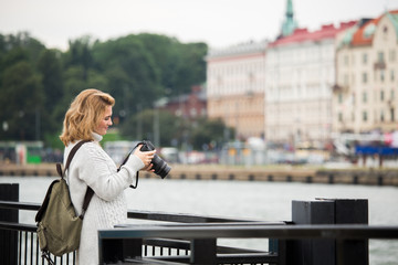 Woman with a camera on the seaside in Europe