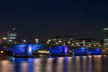 Fototapeta na wymiar Colorful lights on the Southwalk bridge in London at night - 2