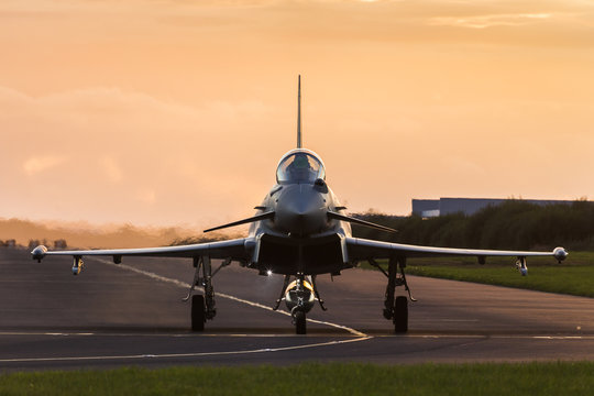 Fototapeta RAF Typhoon taxis out at sunset