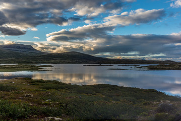 Fototapeta na wymiar Clouds reflecting on a Norwegian lake at sunset in the Rondane National Park in Norway