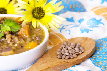 tasty lentil stew on colorful tablecloth